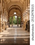 perspective view of one of the corridors with columns and arches at the cemetery of Milan, in Italy