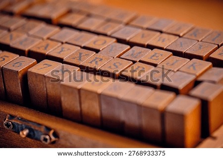 Perspective view rows wooden printer blocks in box, creating sense depth and history