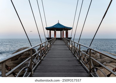 perspective view of the suspension bridge at the seaside - Powered by Shutterstock