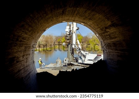 Similar – Image, Stock Photo Engineer managing cables behind solar panels at a solar farm. Alternative energy ecological concept image.