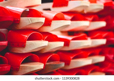 Perspective View Of Wooden Chinese Clogs In Red Color. 