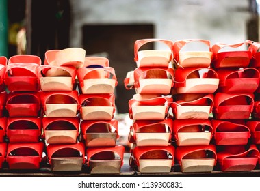 Perspective View Of Wooden Chinese Clogs In Red Color. 