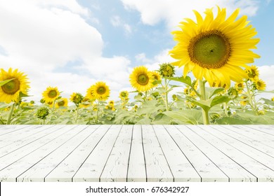 Perspective white wooden table on top over blur sunflowers background, Empty table for Your photo, Great for summer products monatges display or design layout. 
 - Powered by Shutterstock