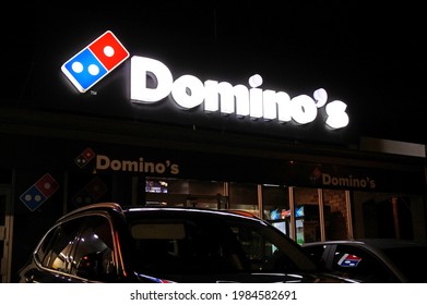 PERT, WA - JUNE 06 2021:Domino's Pizza Store Sign Illuminated Over Night Sky.Domino's Has 8,200+ Stores Worldwide, Which Totaled $1.4 Billion In Gross Income.