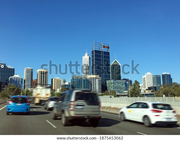 PERTH - DEC 14 2020:Rush hour traffic in Perth\
Western Australia.There are about 18,000,000 cars in\
Australia.That\'s equivalent to 92.5% of households that have a car,\
or almost 2 cars per\
household.