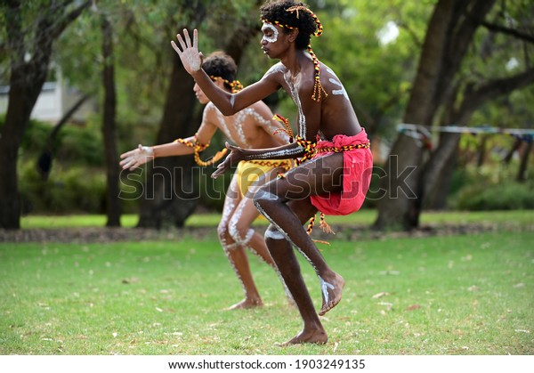 PERTH - JAN 24 2021:Aboriginal Australians men\
dancing traditional dance during Australia Day celebrations.In 2016\
Australian Census, Indigenous Australians comprised 3.3% of\
Australia\'s population