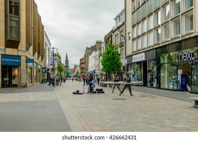 PERTH, SCOTLAND - MAY 24, 2016: Debenhams and Next clothing stores in High Street in Perth, Scotland.