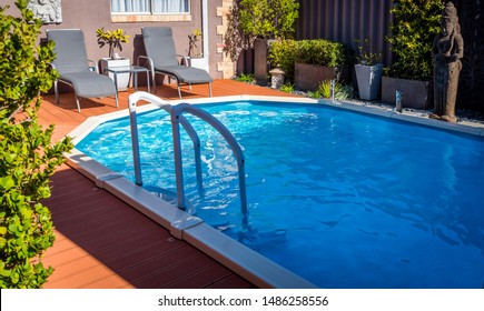 Perth, WA / Australia - 08/19/2019 Above Ground Pool Sunken Below Ground And Surrounded By Decking.