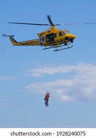 Perth, WA, Australia - March 3 2021: A Rescue Helicopter And Marine Rescue Boat Practice Winching A Paramedic And Dummy Back And Fore.