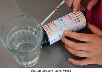 PERTH, WA - DEC 23 2021:Person Testing Drinking Water With A Test Kit On Tap Water Inside A Glass Cup. About 1 To 2 Billion People Lack Safe Drinking Water.