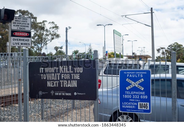 Perth, Western\
Australia, 11 20 2020.\
Safety and maintenance signs attached to a\
weld mesh fence, securing the rail tracks of moving\
trains.\
TransPerth safety\
systems.