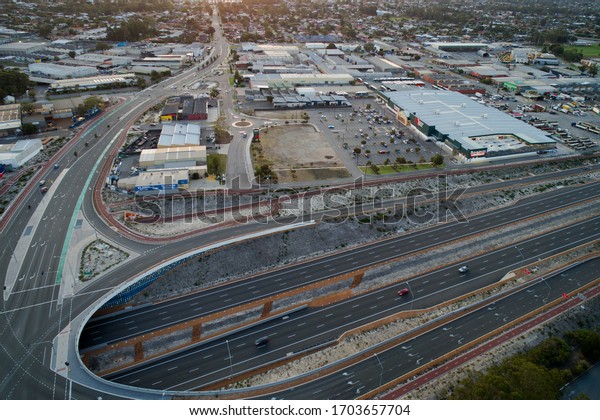 Perth, Western Australia / Australia - April\
13, 2020: Aerial view highway crossing in Perth with business park,\
Western Australia,\
Australia