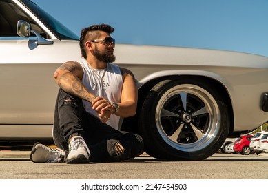 Perth, Western Australia - April 16th 2022: My Mechanic Friend Opening Up The Bonnet Of His Custom Made Car To Repair The Engine And Tightening Screws