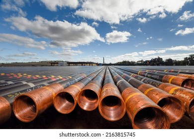 Perth, Western Australia, Aus Apr 1 2016 - Oil And Gas Pipeline Or Production Tubing  Stacked With Threads Cleaned And Gleaming In The Late Sun Ready To Be Connected And Run Down Hole.