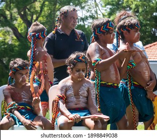 Perth, Western Australia - Jan 26, 2020: A Group Of Young Indigenous Australian Boys Dressed In Traditional Clothing And Body Paint Prepare For A Dance At An Australia Day Celebration Crowd At A Park.