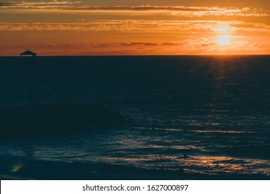 PERTH, WESTERN AUSTRALIA - January 8th, 2020: view of the sunset over the Indian Ocean at City Beach, one of the most popular beaches near Perth on a warm summer day 