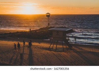PERTH, WESTERN AUSTRALIA - January 8th, 2020: view of the sunset over the Indian Ocean at City Beach, one of the most popular beaches near Perth on a warm summer day 