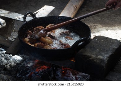 Peruvian culinary: Chicharrones frying in rustic pan.