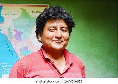 Peruvian Man Smiling. A Map Of Peru In The Background.