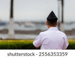 Peruvian marine seen from behind with Callao port in background