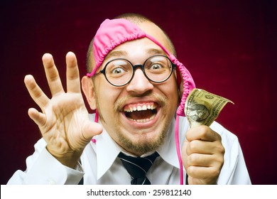 A pervert man with bra on head an a dollar bill on hand