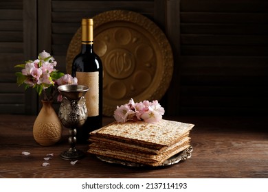 Pesach background. Passover celebration with wine and matzo on the wooden background. (Jewish Passover holiday)