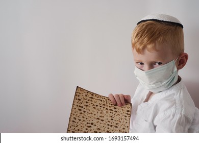 Pesach and Coronavirus epidemic. Child in medical mask and matzah for Pesach.