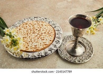 Pesah celebration concept, jewish Passover holiday. Matzah and red kosher. Traditional ritual Jewish bread on travertine stone background