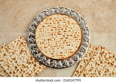 Pesah celebration concept, jewish Passover holiday. Traditional ritual Jewish bread on travertine stone background