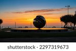 PESARO, IT - Jul 15, 2022: A beautiful shot of a silhouette of the sphere sculpture by Arnaldo Pomodoro in Pesaro during the sunset