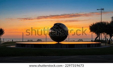 PESARO, IT - Jul 15, 2022: A beautiful shot of a silhouette of the sphere sculpture by Arnaldo Pomodoro in Pesaro during the sunset