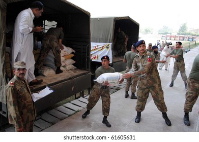 PESHAWAR, PAKISTAN, SEPT 23: Army officials shift relief goods from trucks which were donated by army and civilians of Punjab for flood affectees of Khyber-Pakhtoonkhawa, September 23, 2010 in Peshawar, Pakistan in Peshawar on Thursday,
