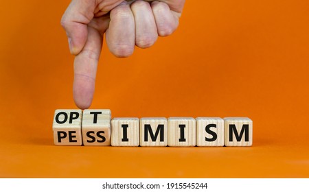 Pessimism Or Optimism Symbol. Businessman Turns Cubes And Changes The Word 'pessimism' To 'optimism'. Beautiful Orange Table, Orange Background. Business And Optimism Or Pessimism Concept. Copy Space.