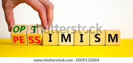 Pessimism or optimism symbol. Businessman turns cubes and changes the word 'pessimism' to 'optimism'. Beautiful yellow table, white background. Business, optimism or pessimism concept. Copy space. Foto stock © 