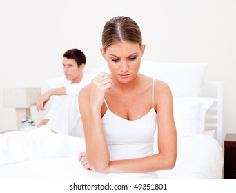 Pessimistic couple having an argument  sitting on bed - Powered by Shutterstock