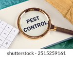 Pest control phrase written through a magnifying glass in a business book