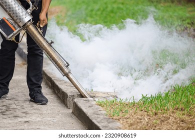 pest control staff spray chemical smoke eliminate mosquito larvae rats cockroach bugs in drains ground outdoor. - Powered by Shutterstock