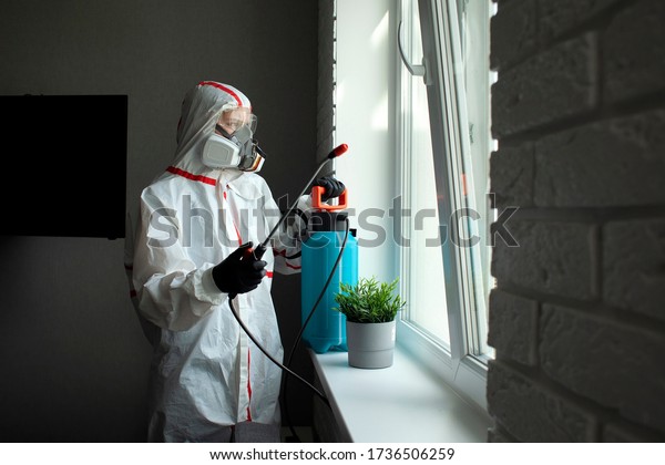 pest
control. A worker in a protective suit cleans the room from
cockroaches and rats with a spray gun, the sanitary service
disinfects the apartment with a chemical
agent