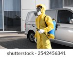 Pest control worker with spray tank outdoors