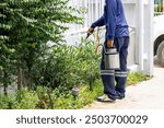 Pest control worker spraying insecticide, Termite extermination expert