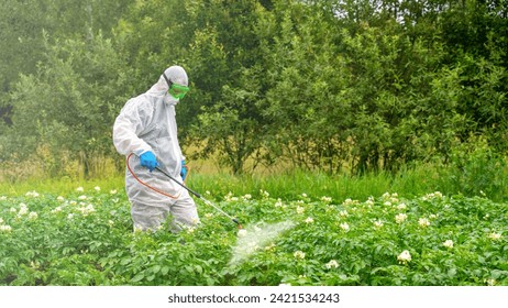 Pest control worker spraying insecticides or pesticides outdoors. The topic of industrial agriculture. - Powered by Shutterstock