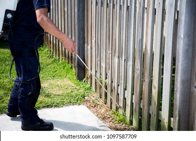 Pest Control Worker Spraying Pesticide outside the house