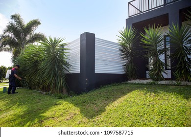 Pest Control Worker Spraying Pesticide Outside The House