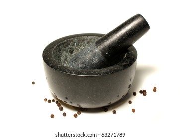 A Pestel And Mortar With Pepper Corns