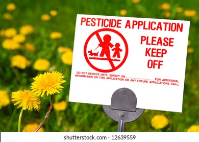 Pesticide Application Sign With Dandelions In The Background