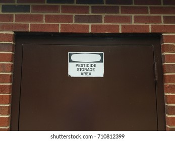 Pesticide Storage Area Sign On Door And Brick Building