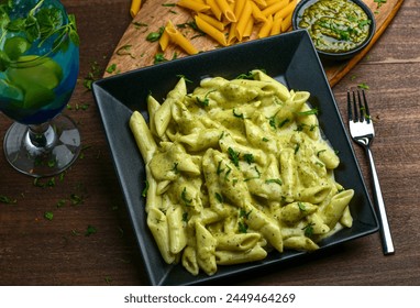 Pesto Pasta; Fresh pasta mixed with fresh creamy sauce on bed of basil pesto. - Powered by Shutterstock