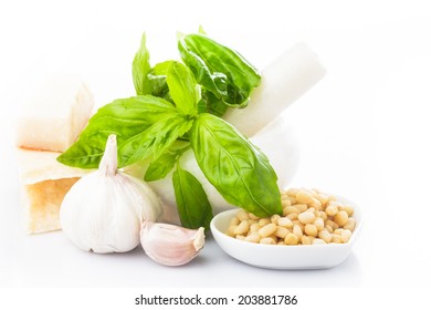 Pesto sauce ingredients: fresh green basil, parmesan, pine nuts and garlic. On white - Powered by Shutterstock