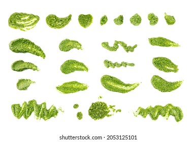 Pesto spread or blob isolated on white background. Green italian homemade spilled sauce made of ground basil, garlic, pine seeds, olives and pecorino sardo cheese top view - Shutterstock ID 2053125101