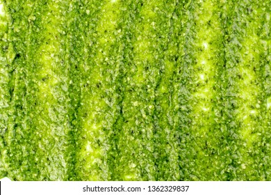 Pesto Spread Pattern, Texture On White Background. Green Italian Homemade Spilled Sauce Made Of Ground Basil, Garlic, Pine Seeds, Olives And Pecorino Sardo Cheese Top View